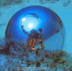 SELF PORTRAIT WITH DIVER IN THE SURFACE AND SUNLIGHT REFL... by Alberto Romeo 